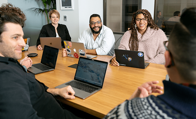 Coworkers talking around table