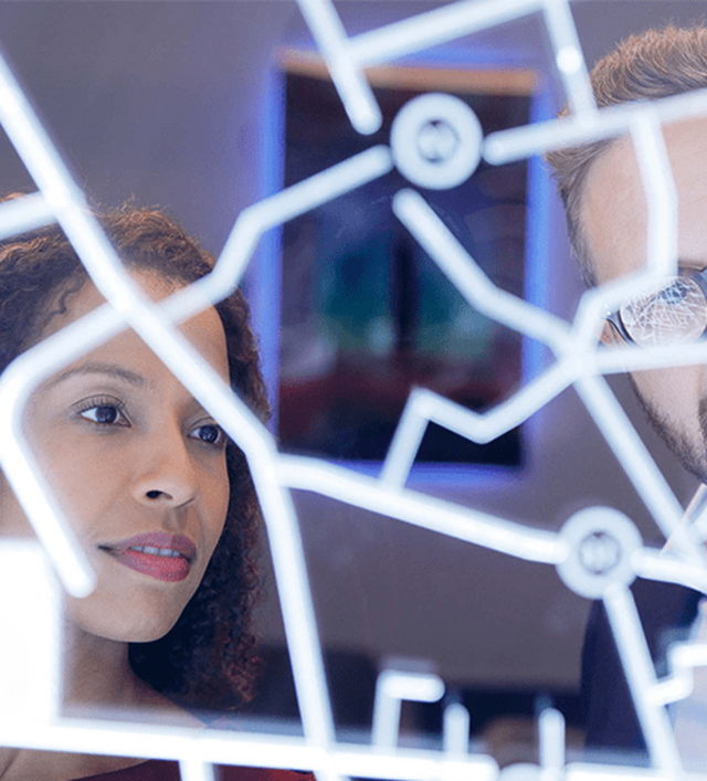 Two people looking at digital screen