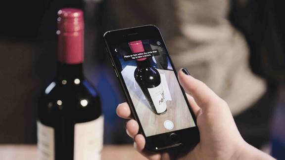 Person doing visual search of a bottle of wine with the smartphone