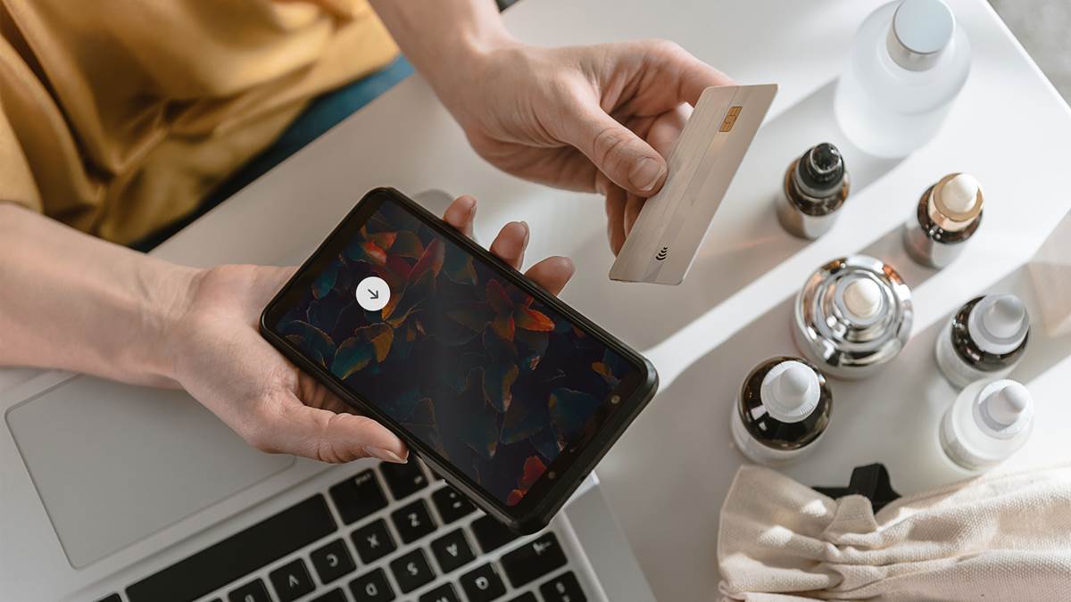 Top view of woman shopping online holding a cell phone