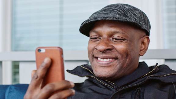 Man smiling at phone