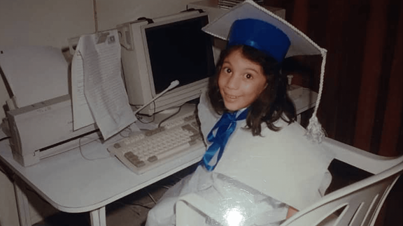 Photo of Laura as a child, at a computer