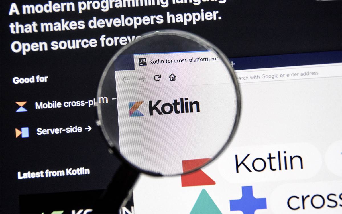 Magnifying glass over screen with Kotlin logo