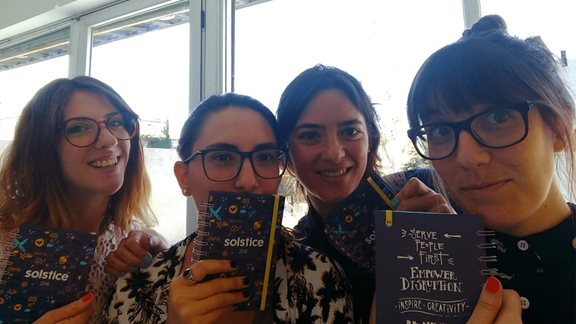 Ceci with her teammates holding branded Solstice books