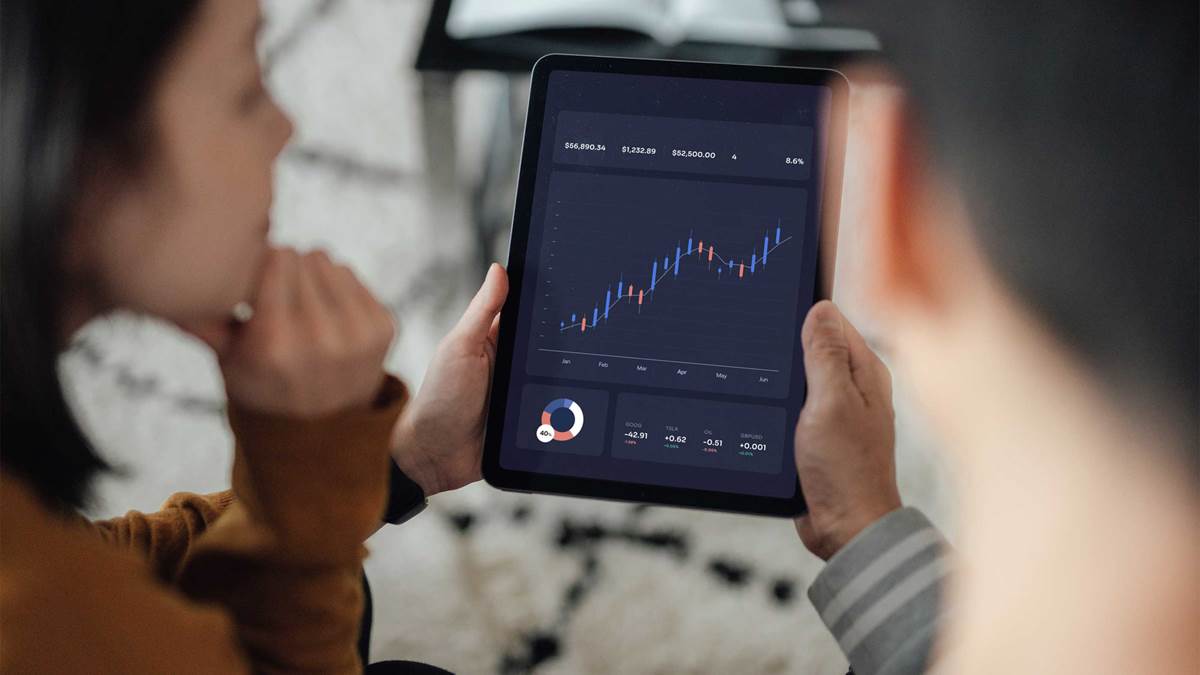 Woman and man looking at data on a tablet device