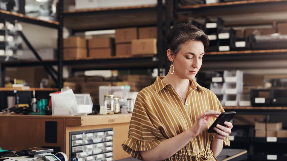 Warehouse worker looking at phone