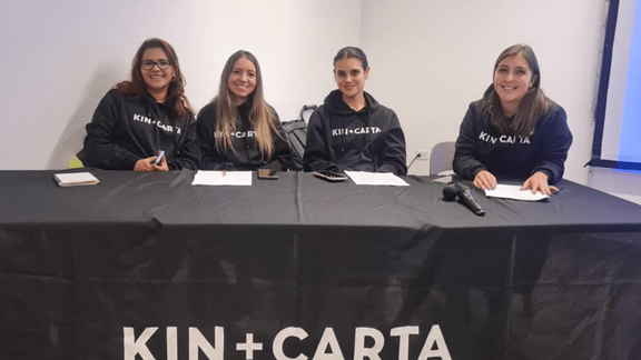 Andrea and her colleagues hosting a panel in a Kin + Carta event
