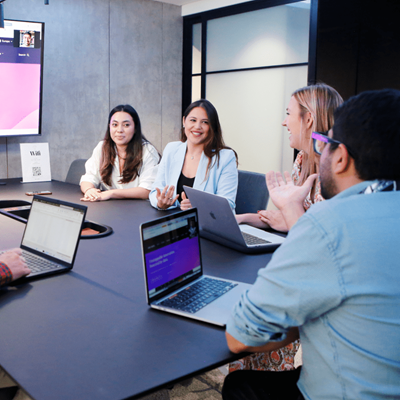 Image of individuals collaborating at a table in an office room