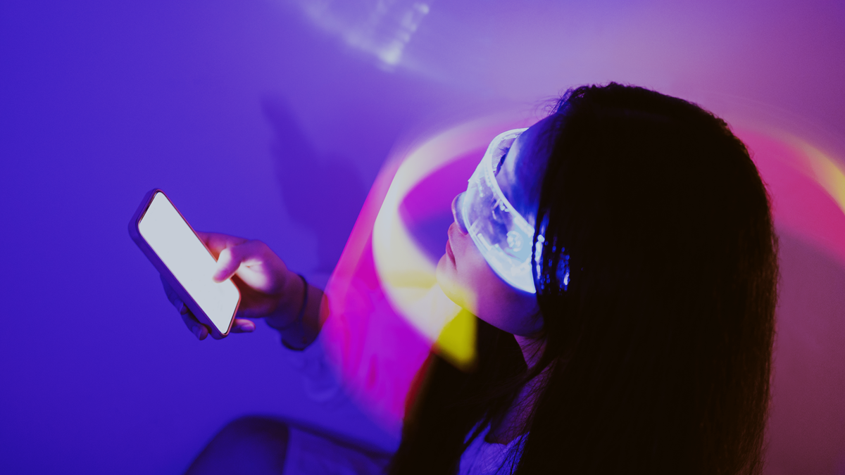 Woman with lights around her head holding a phone