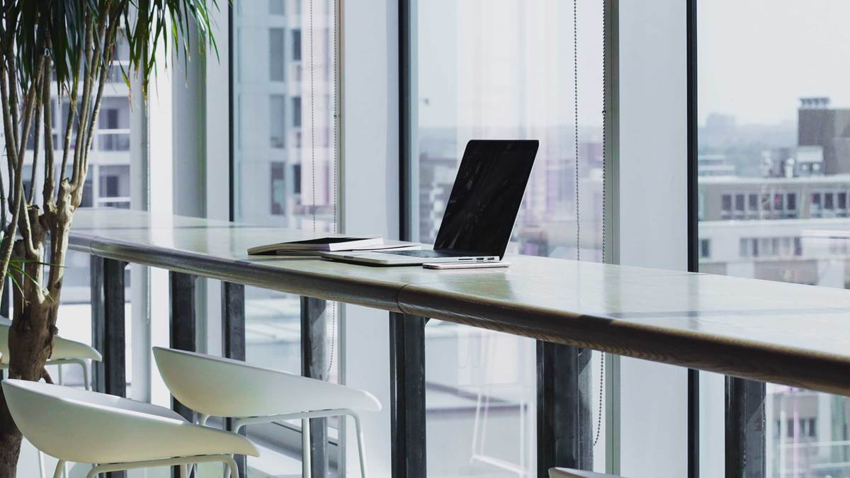 Laptop on desk with city view
