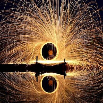 figure reflected in a shower of sparks