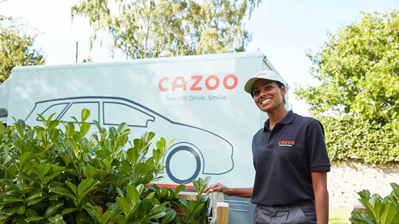 Woman standing in front of Cazoo branded truck