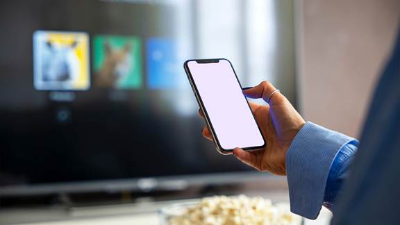 User receiving a mobile notification while watching television