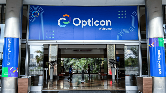Double door entrance with overhead banner over that reads: Opticon, welcome