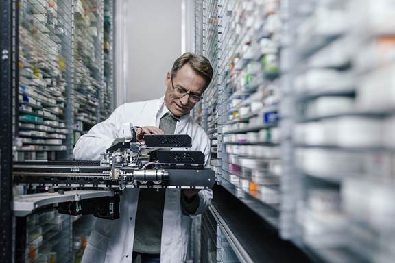 Pharmacist checking the technology of his order picking machine