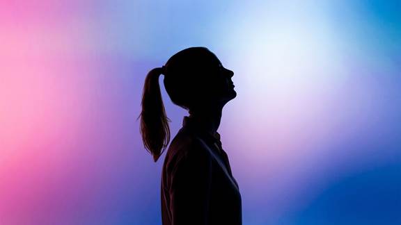 Silhouette of woman over a colorful gradient background