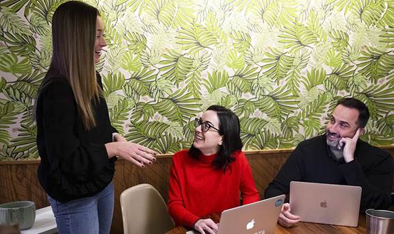 Employees in office with Macbooks