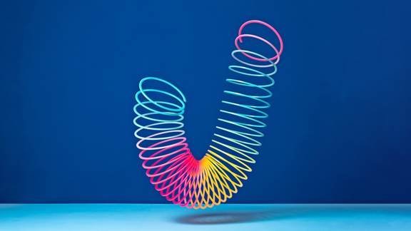 Slinky toy flexing over a blue background